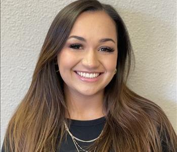 Female employee in front of gray background